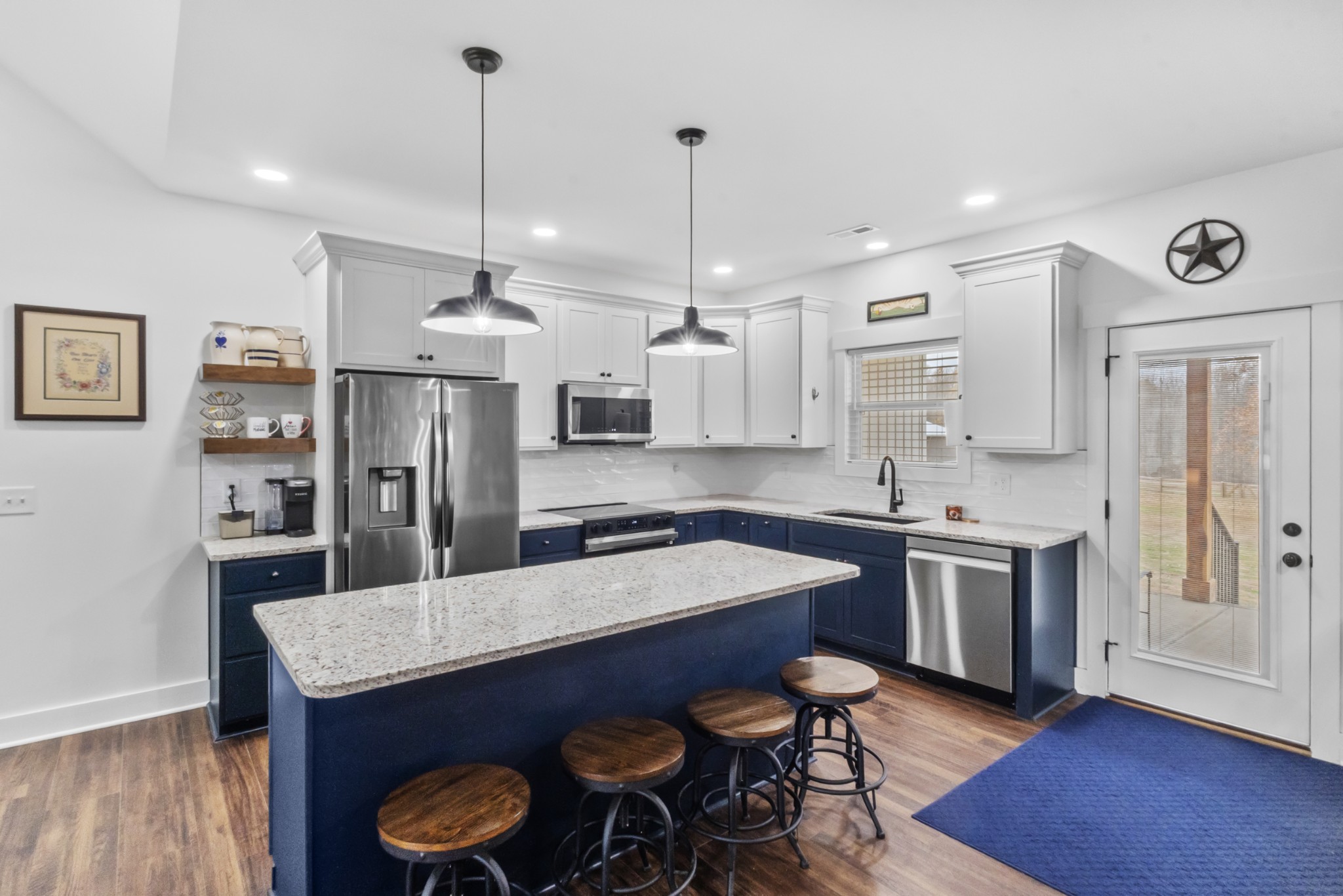 249 Claypool Road Bethpage, TN 37022 - Photo 17 of 53 a kitchen with stainless steel appliances granite countertop a sink a stove a refrigerator and island with wooden floor