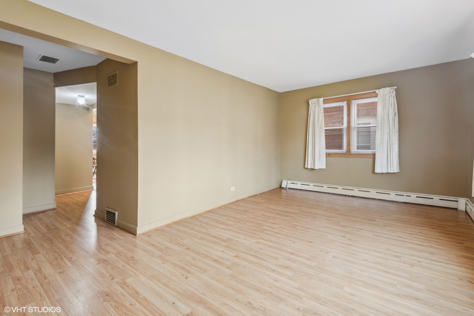 5225 North Rutherford Avenue Chicago, IL 60656 - Photo 3 of 18 a view of an empty room with wooden floor and a window