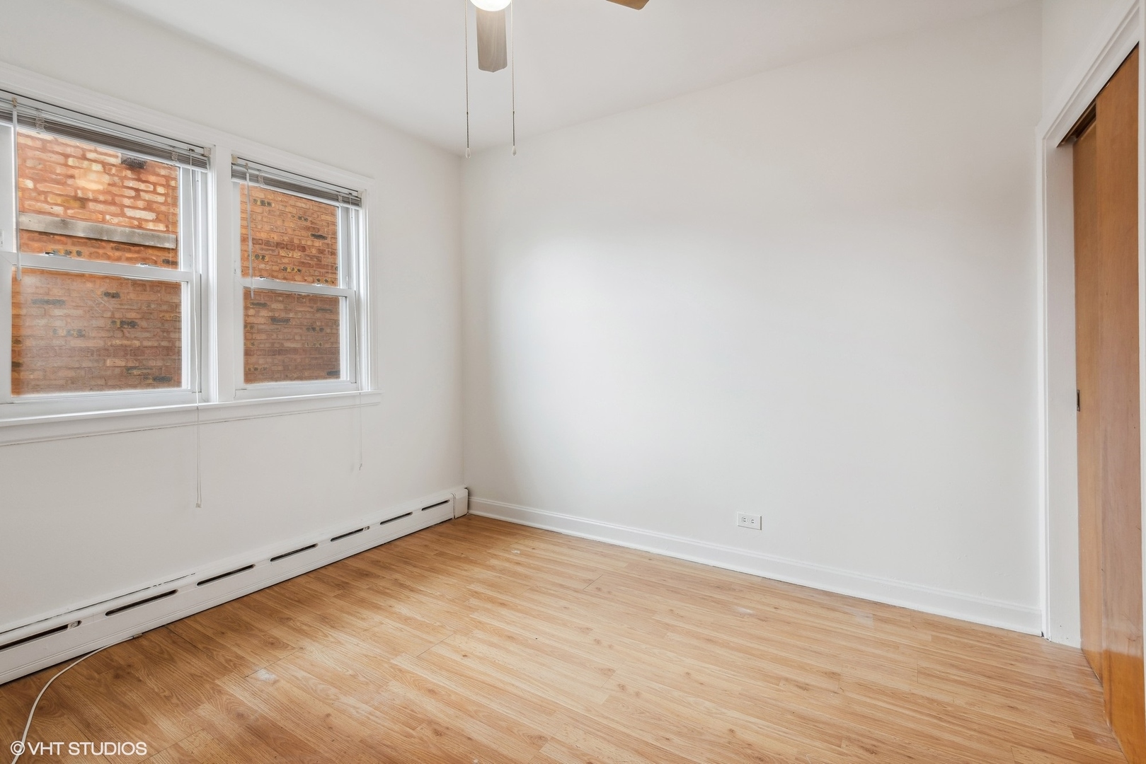5225 North Rutherford Avenue Chicago, IL 60656 - Photo 8 of 18 an empty room with wooden floor and windows