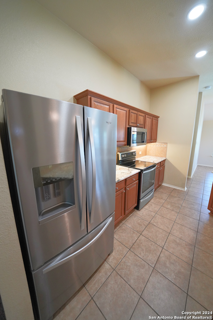 15805 Fair Lane Selma, TX 78154 - Photo 16 of 50 a metallic refrigerator freezer sitting inside of a kitchen