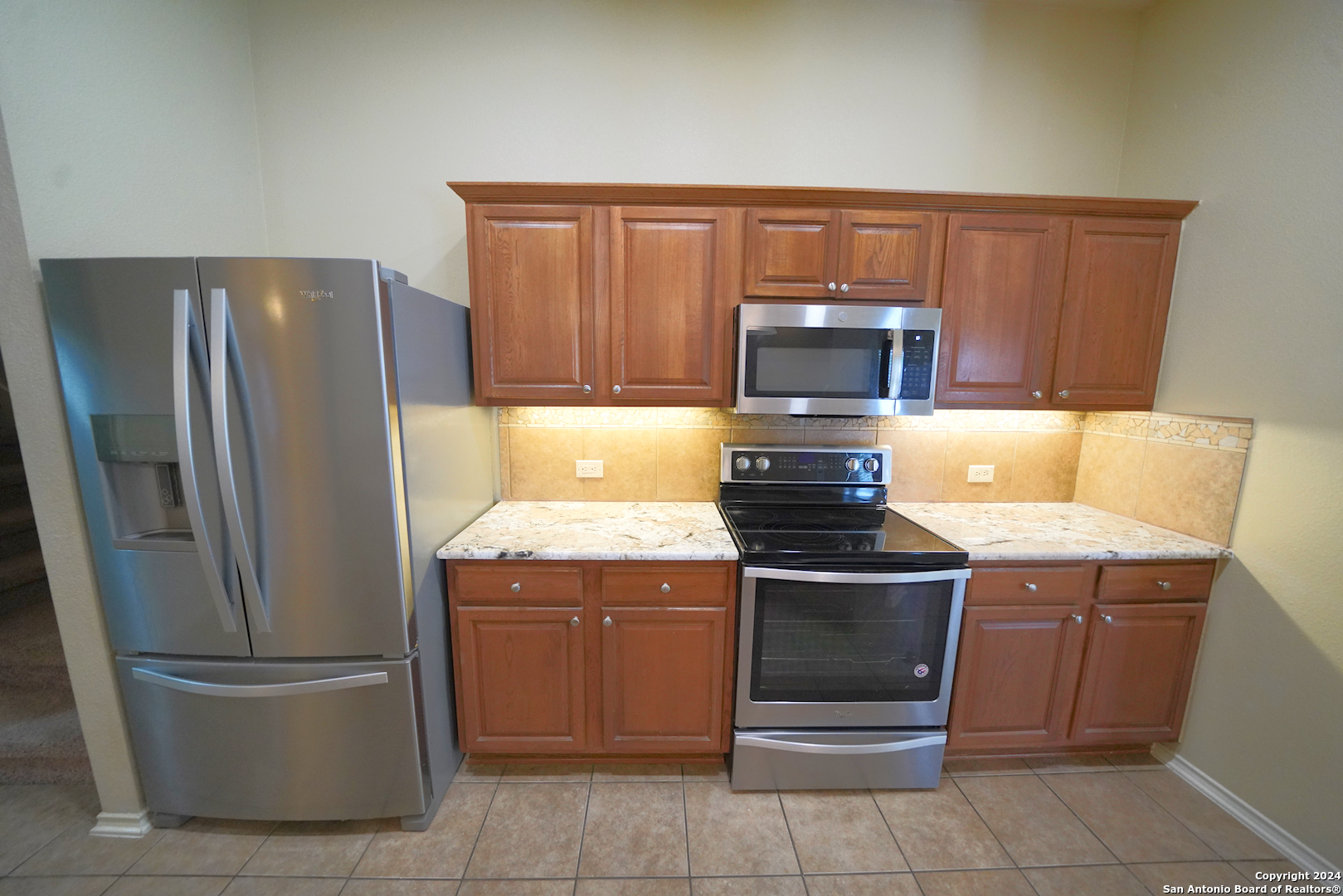 15805 Fair Lane Selma, TX 78154 - Photo 18 of 50 a kitchen with a stove top oven and refrigerator