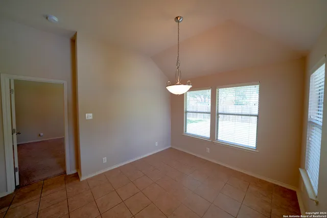 a view of an empty room with windows