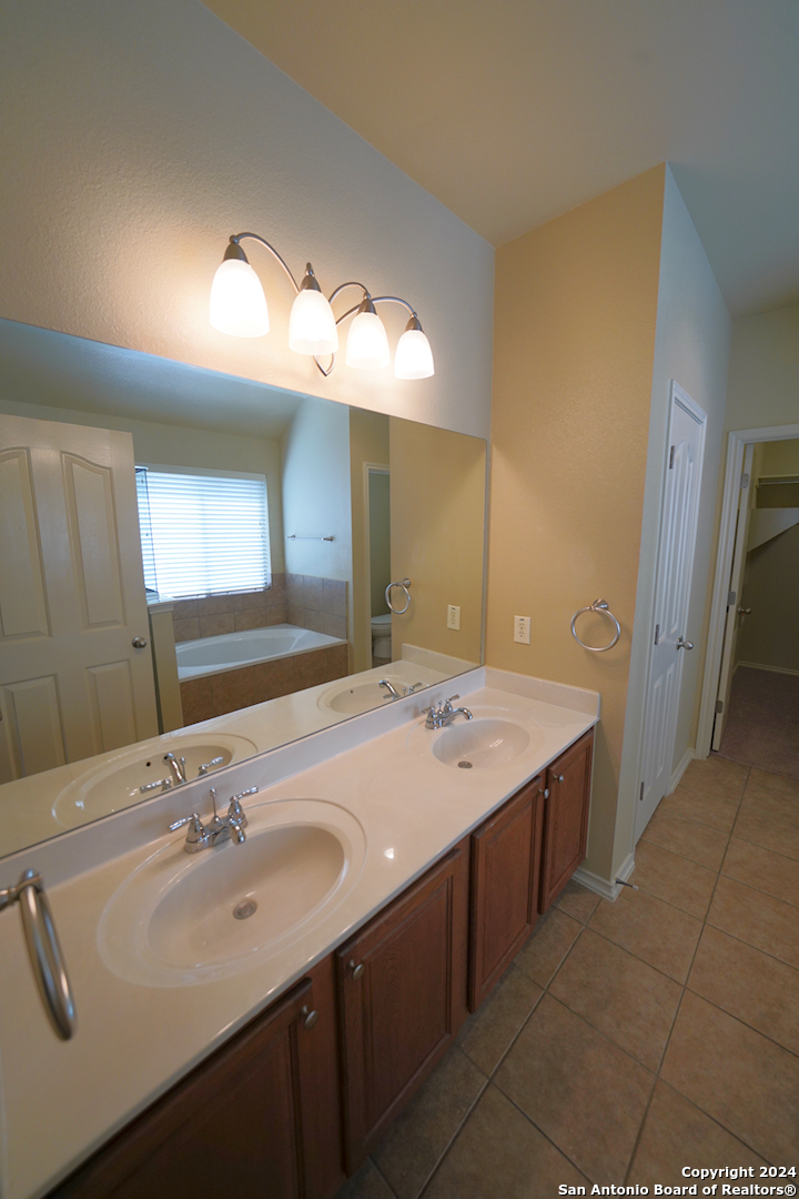 15805 Fair Lane Selma, TX 78154 - Photo 28 of 50 a bathroom with a sink and a mirror