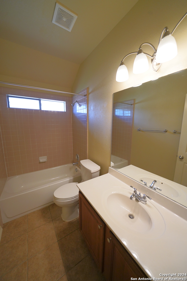 15805 Fair Lane Selma, TX 78154 - Photo 35 of 50 a bathroom with a double vanity sink toilet and a bathtub