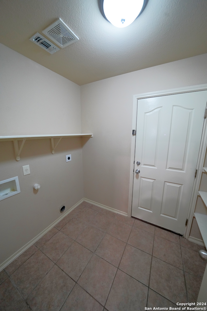 15805 Fair Lane Selma, TX 78154 - Photo 40 of 50 a view of storage and utility room with empty racks