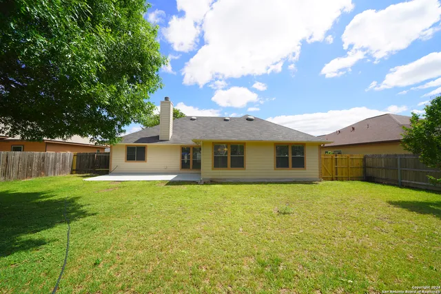 a front view of house with yard and trees