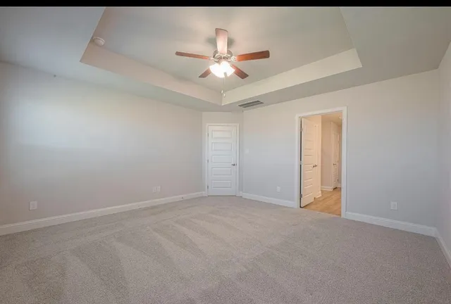 a large kitchen with granite countertop a stove top oven a sink a counter space and cabinets