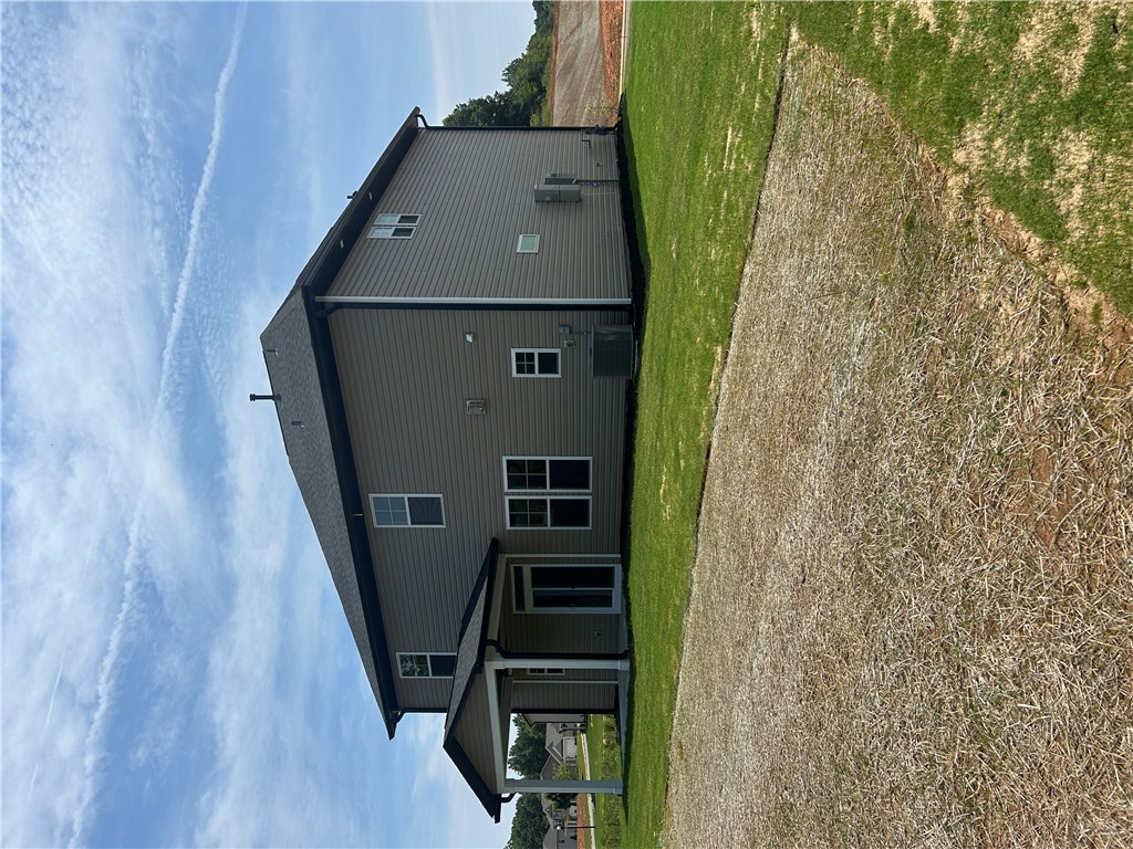 202 Bellflower Lane Pendleton, SC 29670 - Photo 27 of 27 A newly constructed residence showcasing classic siding, a gabled roofline, and ample yard space.