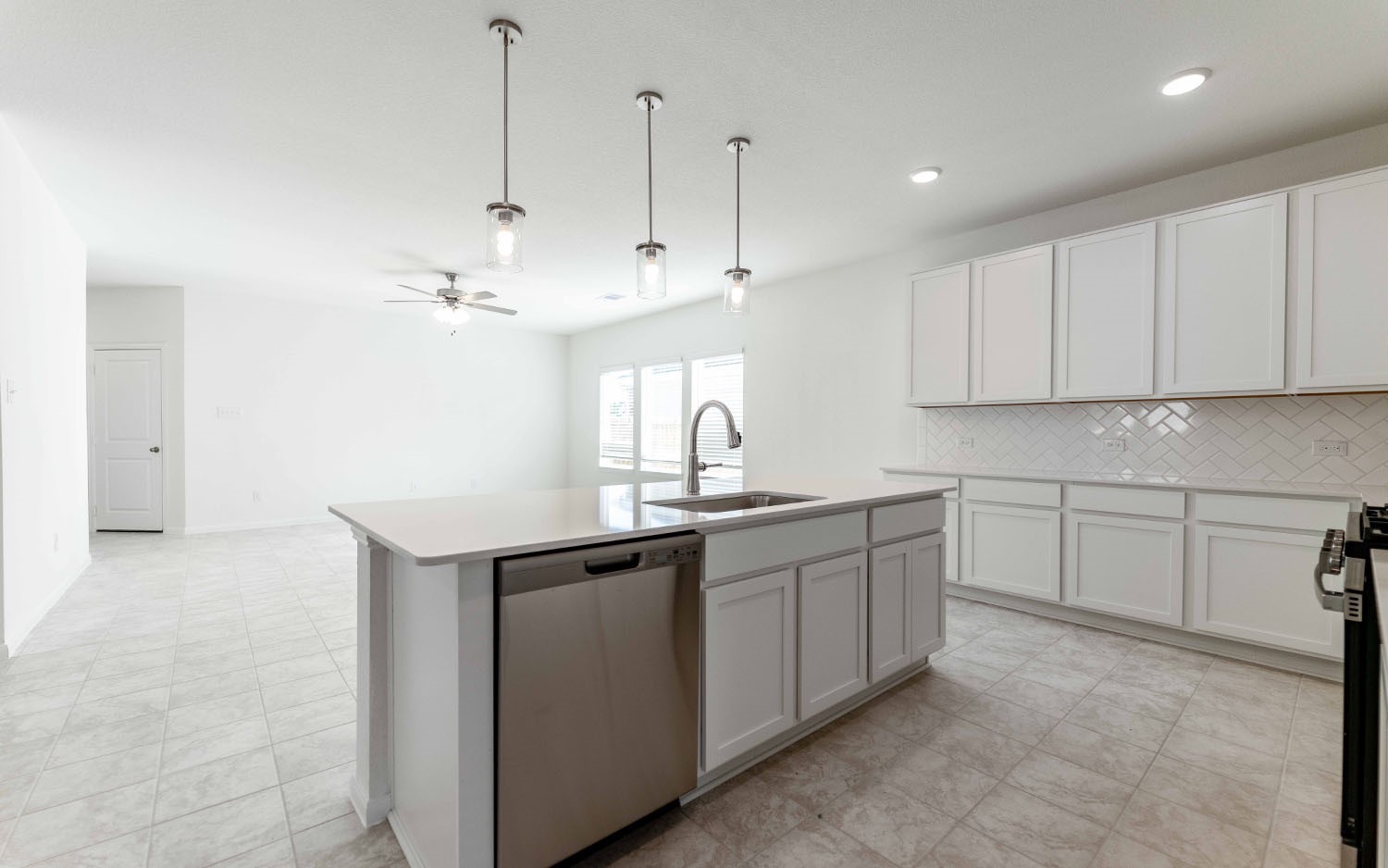 428 Monarch Trail Huntsville, TX 77340 - Photo 8 of 16 a kitchen with kitchen island white cabinets appliances and a sink