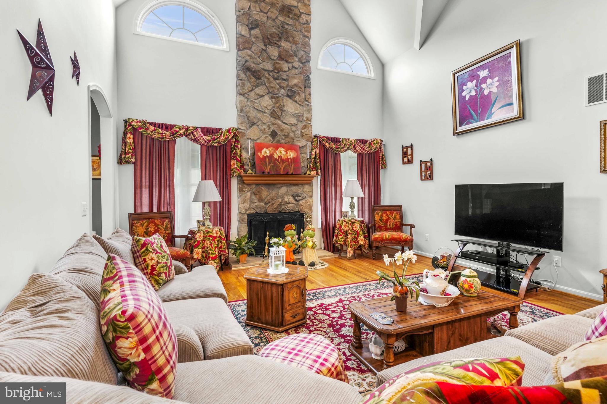 94 Friendship Road Friendship, MD 20758 - Photo 11 of 40 a living room with fireplace furniture and a flat screen tv