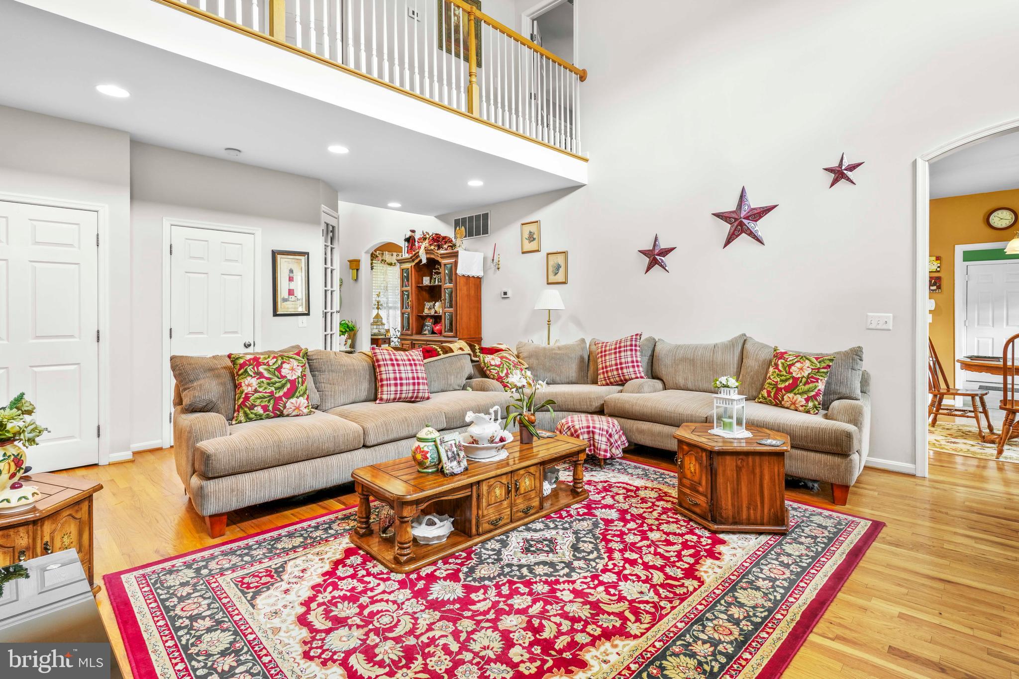 94 Friendship Road Friendship, MD 20758 - Photo 13 of 40 a living room with furniture a rug and a wooden floor