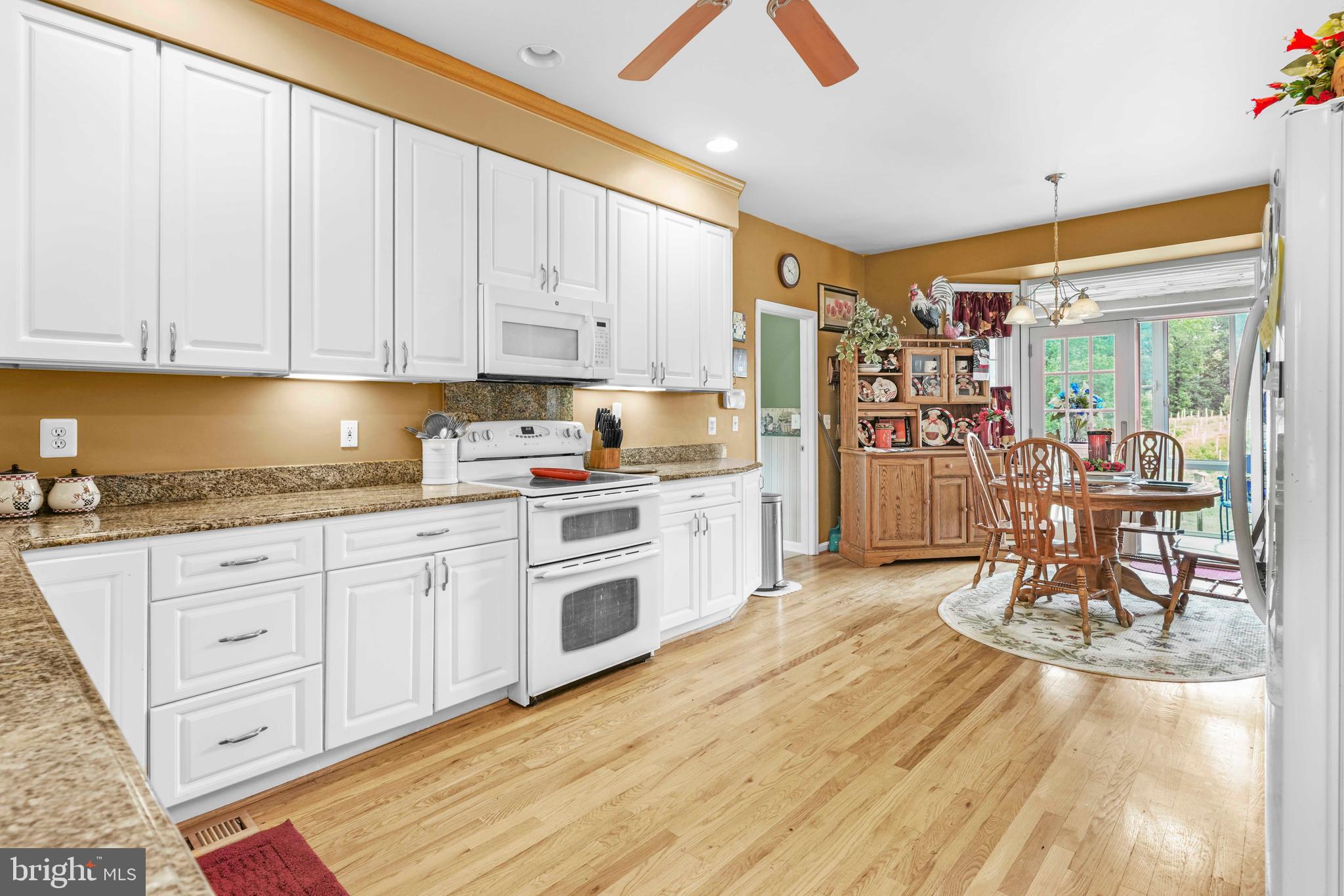94 Friendship Road Friendship, MD 20758 - Photo 5 of 40 a kitchen with stainless steel appliances granite countertop a stove and white cabinets