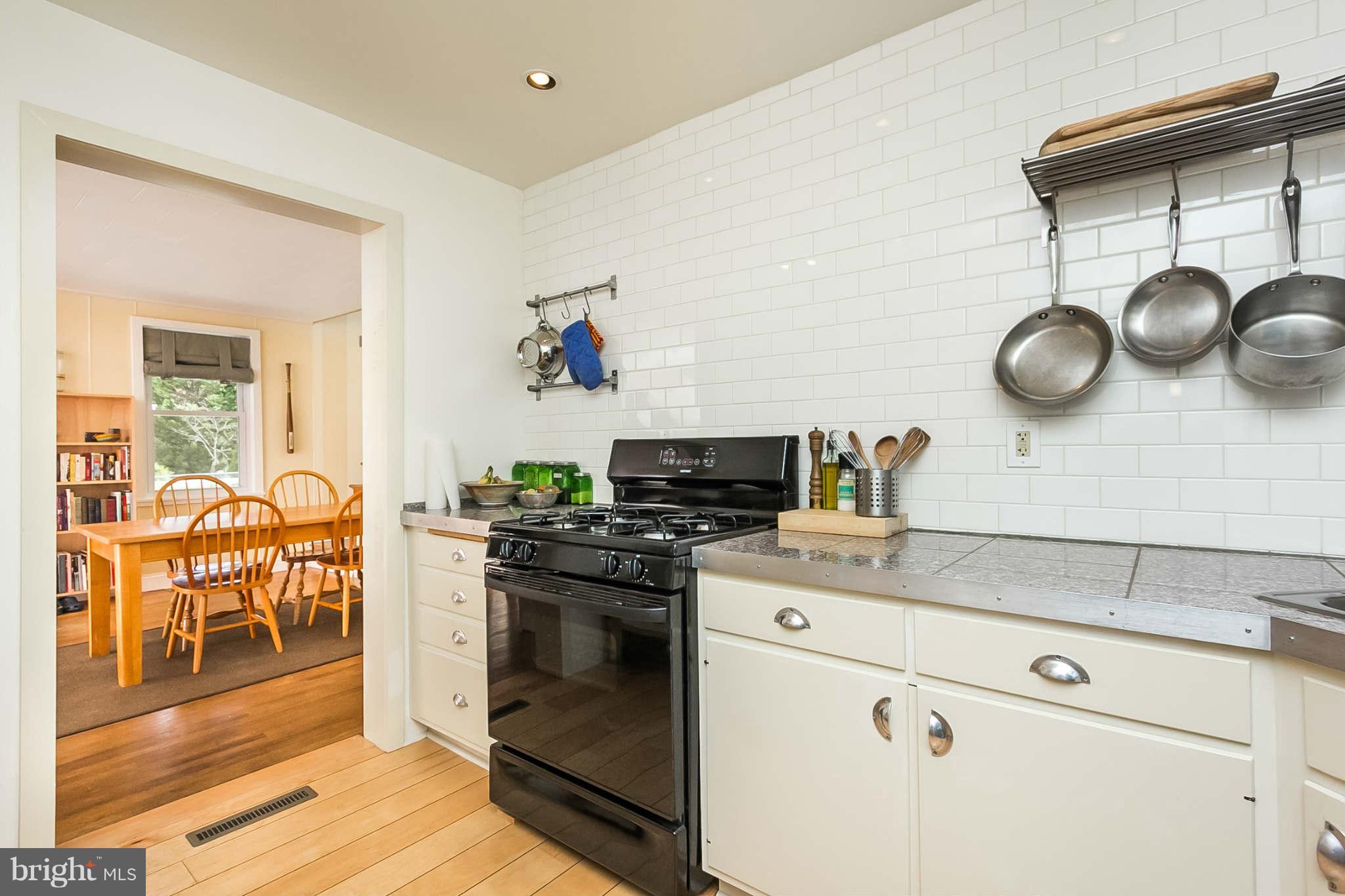 5506 Tramore Road Baltimore, MD 21214 - Photo 11 of 30 a kitchen with a stove and a wooden floor