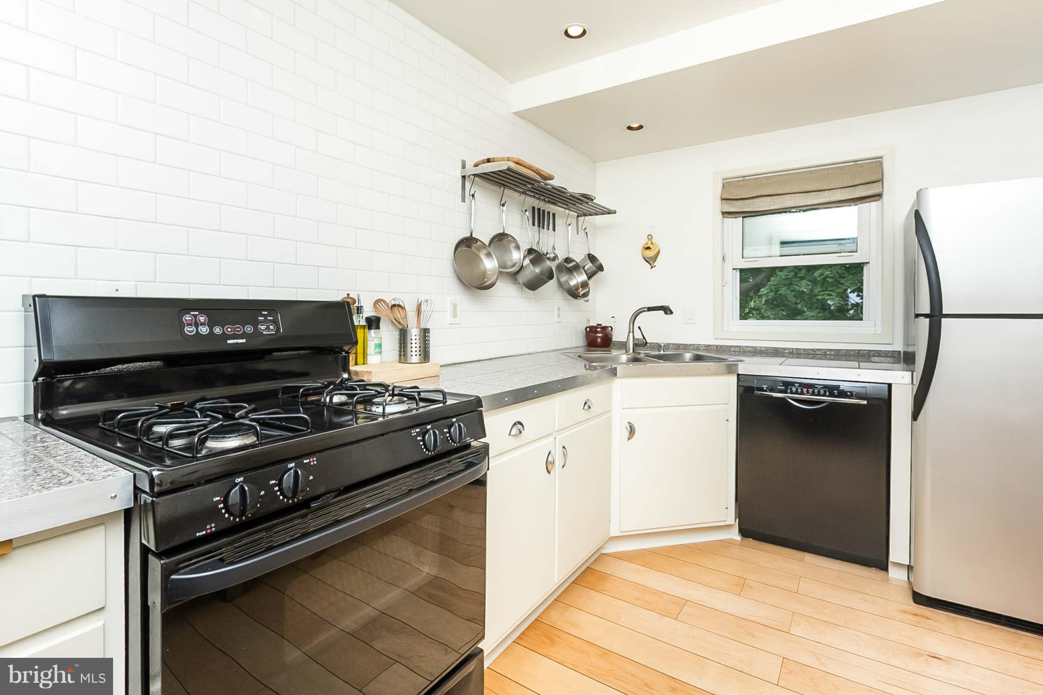 5506 Tramore Road Baltimore, MD 21214 - Photo 13 of 30 a kitchen with a stove and a microwave