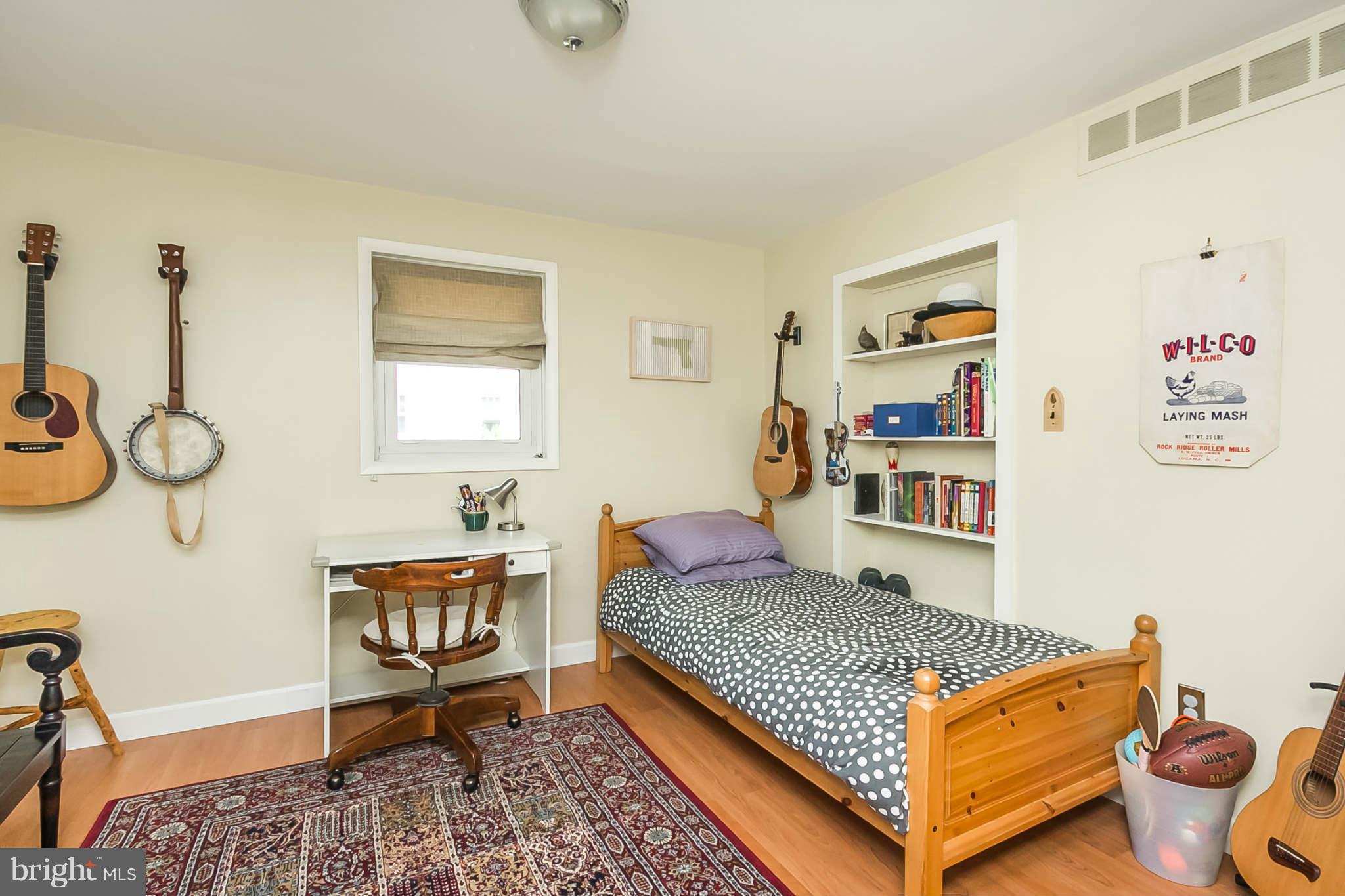 5506 Tramore Road Baltimore, MD 21214 - Photo 16 of 30 a bedroom with furniture and a book shelf