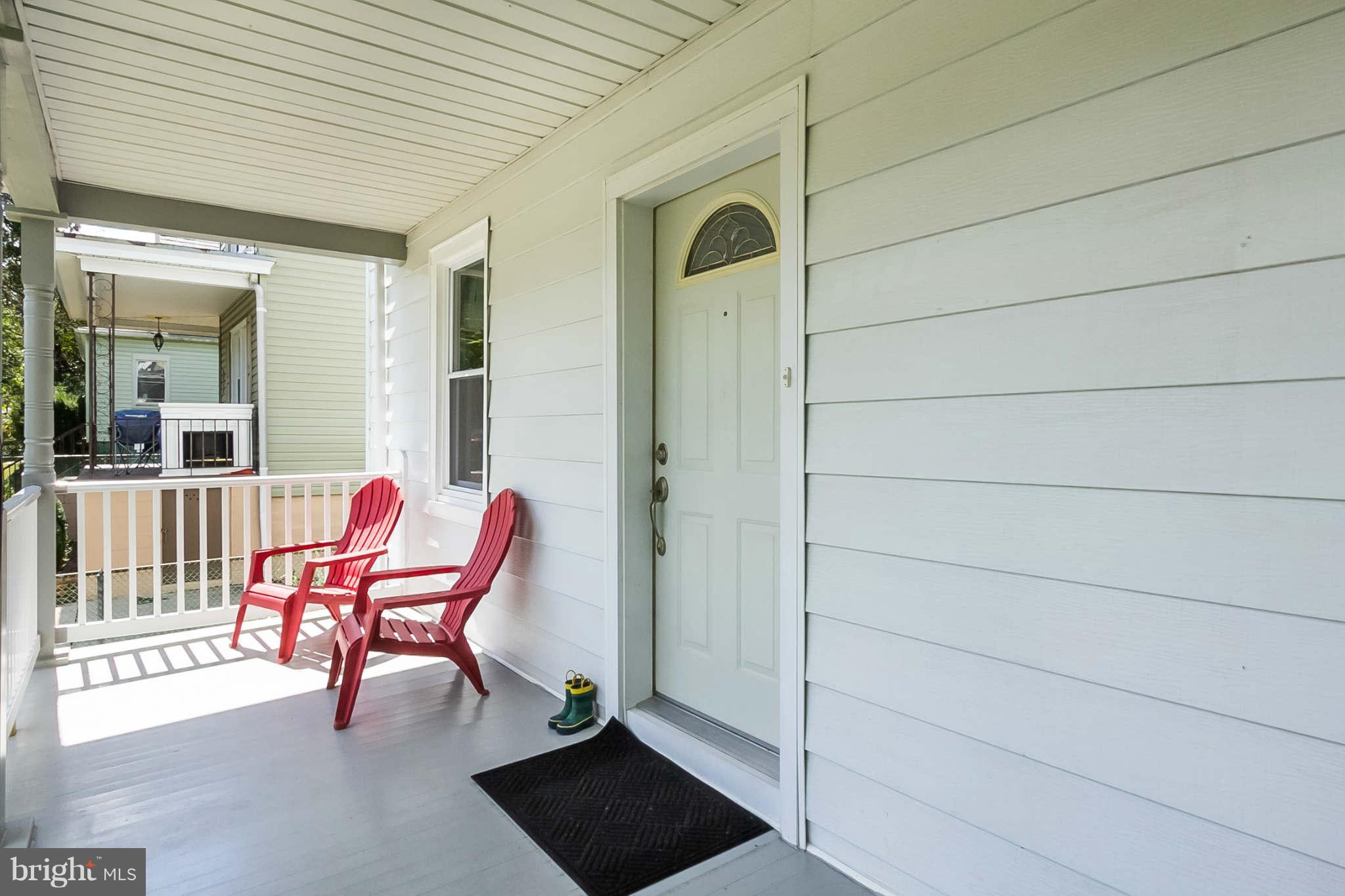 5506 Tramore Road Baltimore, MD 21214 - Photo 3 of 30 a porch with a bench and a chair