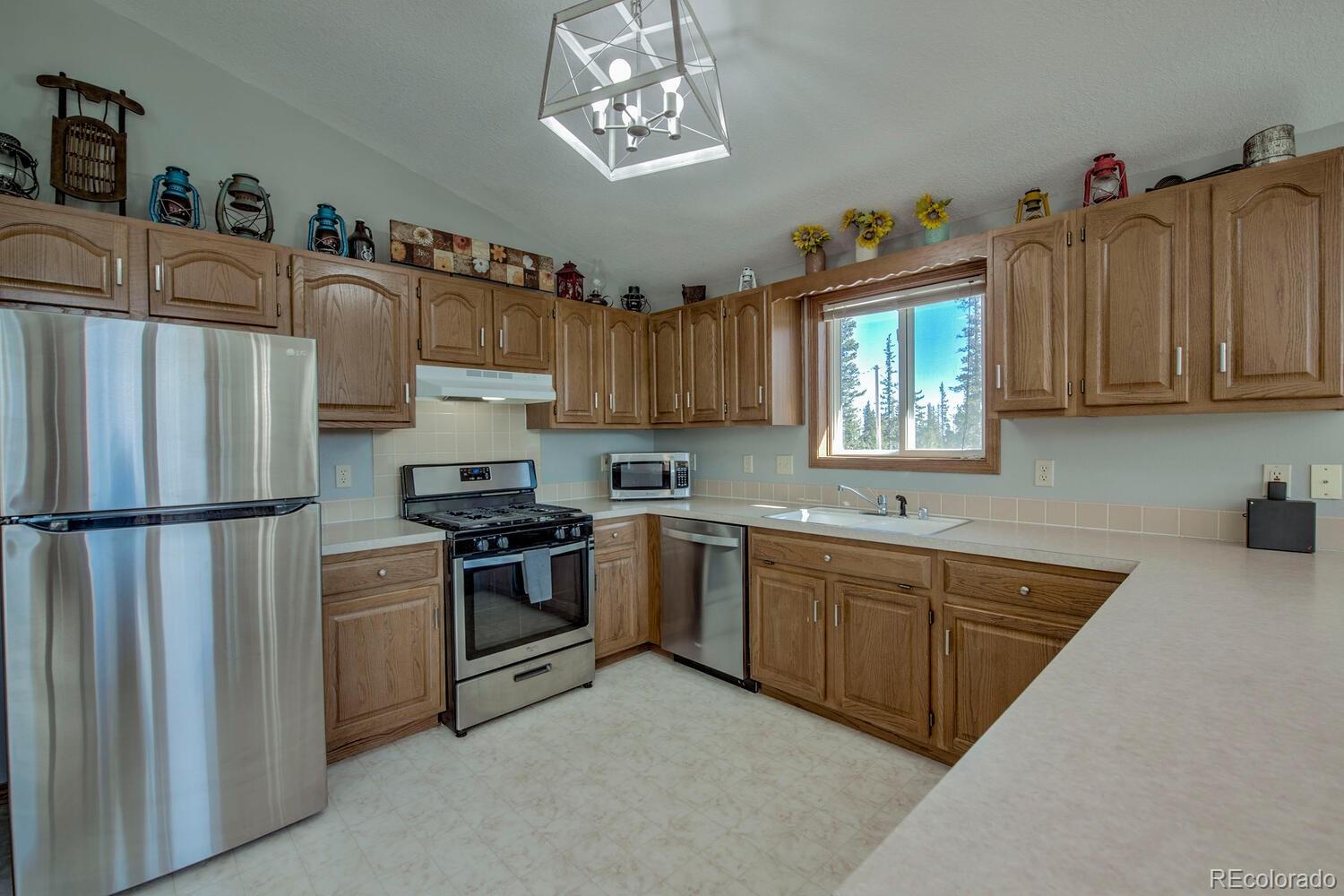 394 Co Road Fairplay, CO 80440 - Photo 21 of 46 a kitchen with stainless steel appliances granite countertop a refrigerator sink and cabinets