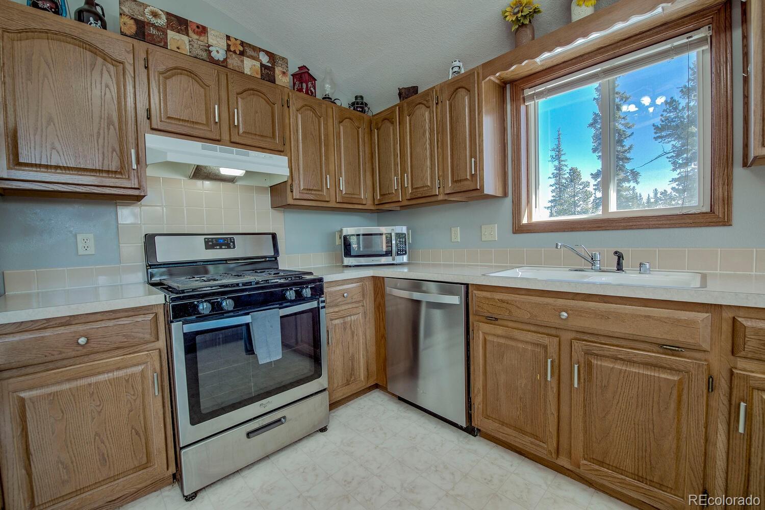 394 Co Road Fairplay, CO 80440 - Photo 22 of 46 a kitchen with stainless steel appliances granite countertop a stove a sink and a microwave