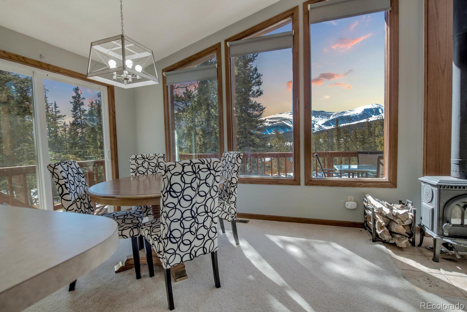 394 Co Road Fairplay, CO 80440 - Photo 6 of 46 a dining room with furniture large windows and wooden floor