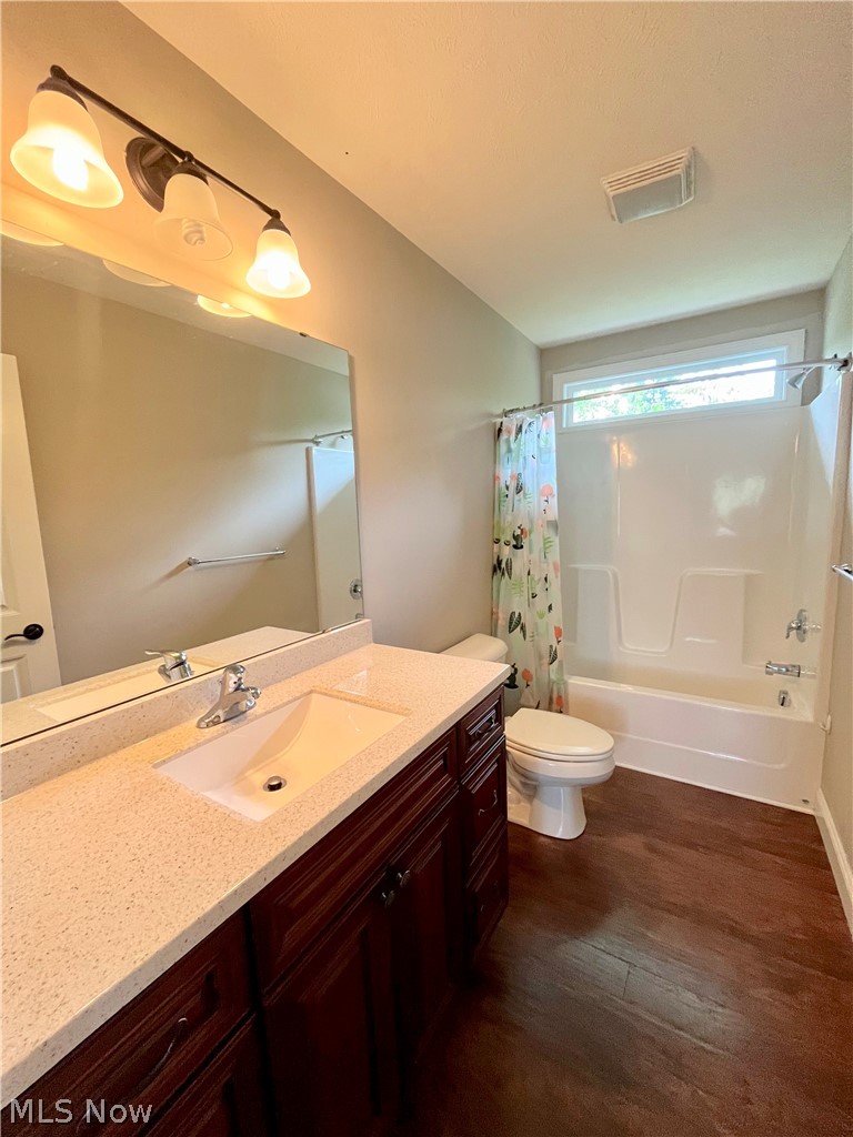 1134 Mayfield Ridge Road Cleveland, OH 44124 - Photo 30 of 41 Full bathroom with wood-type flooring, vanity, toilet, and shower / tub combo