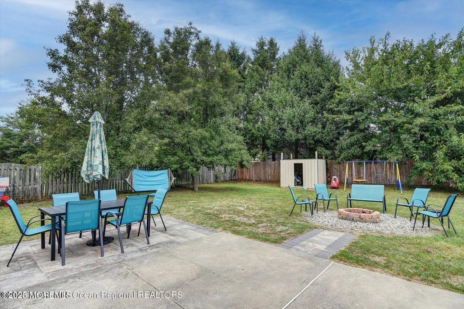 3 Albatross Drive Howell, NJ 07731 - Photo 13 of 16 a backyard of a house with table and chairs