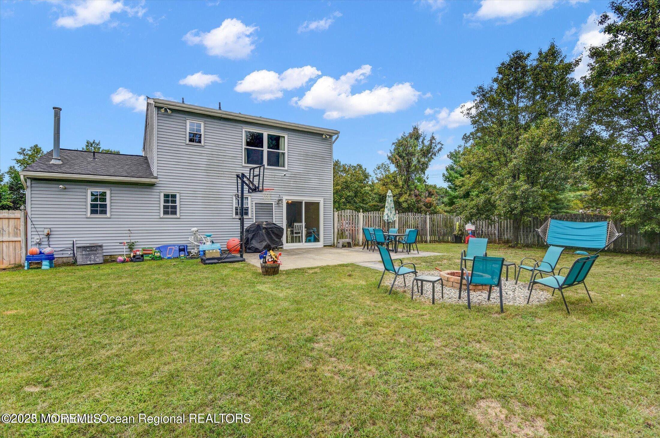 3 Albatross Drive Howell, NJ 07731 - Photo 16 of 16 a view of a backyard with table and chairs and potted plants
