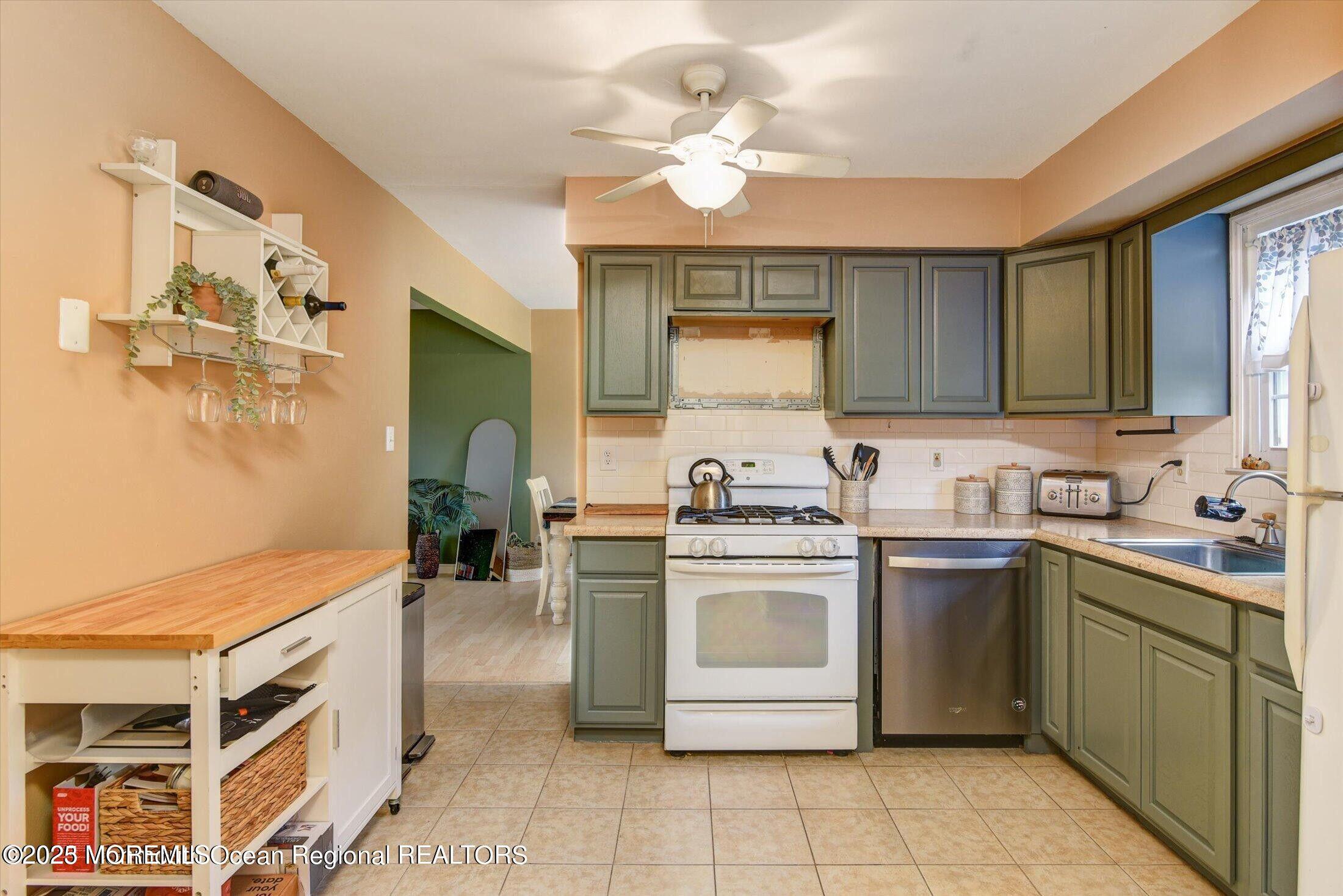 3 Albatross Drive Howell, NJ 07731 - Photo 6 of 16 a kitchen with a stove sink and cabinets