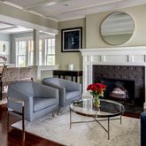 a living room with furniture a window and a fireplace