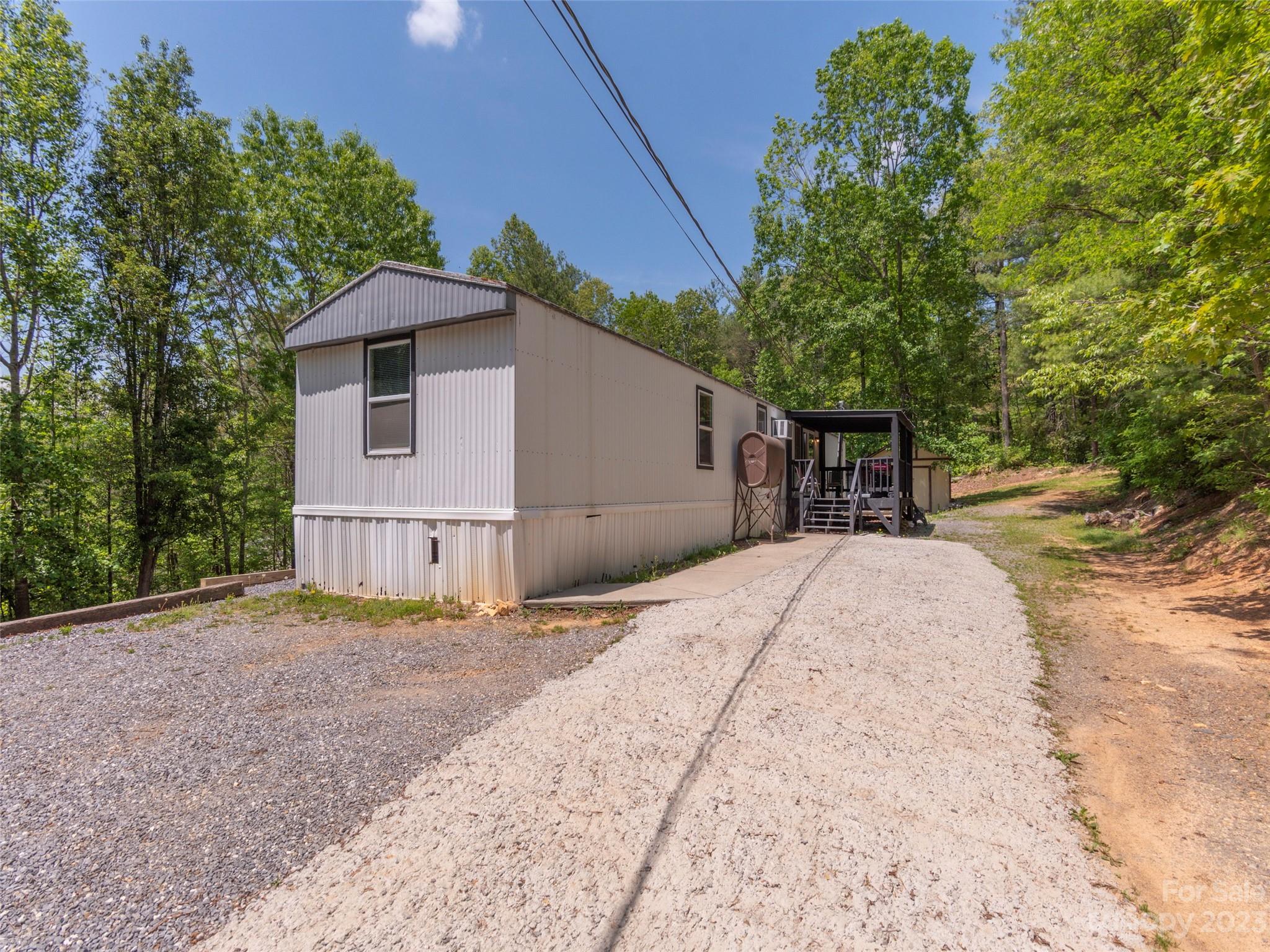18 Autumn Mist Drive Fairview, NC 28730 - Photo 16 of 22 a front view of a house with a yard and garage