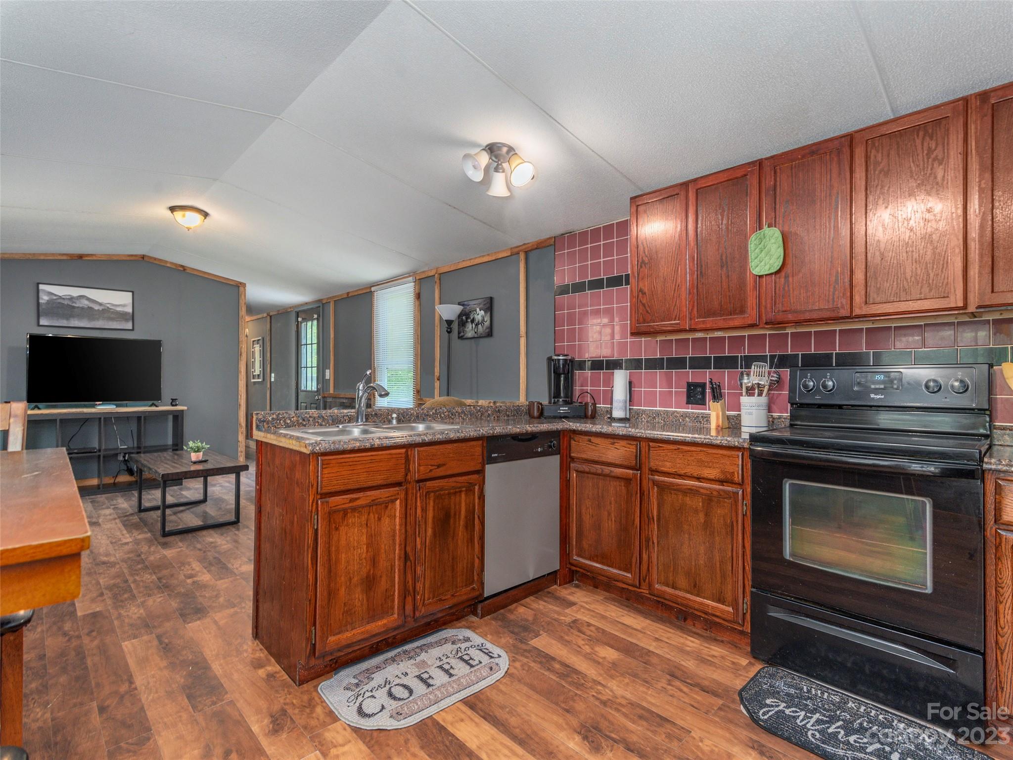 18 Autumn Mist Drive Fairview, NC 28730 - Photo 4 of 22 a kitchen with stainless steel appliances granite countertop a stove a sink and a microwave