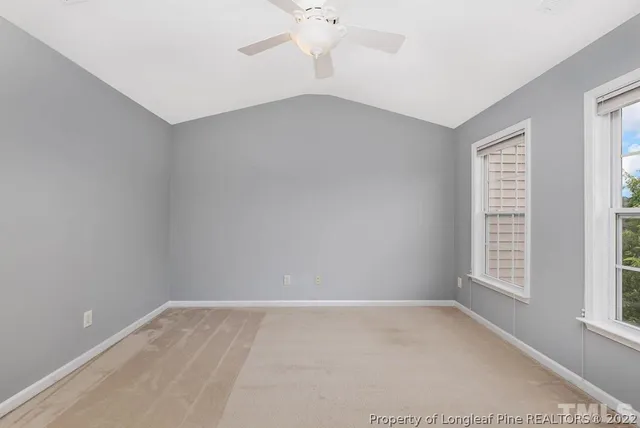 an empty room with windows and entrance