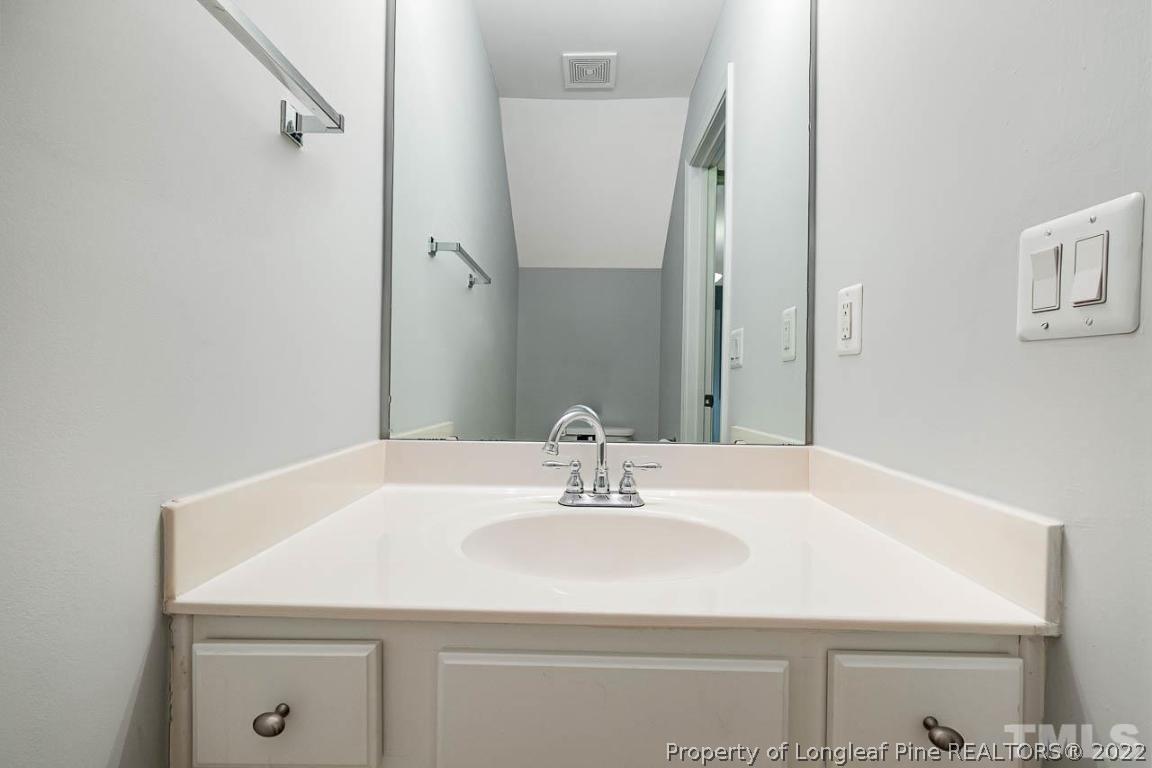 5441 Golden Arrow Lane Raleigh, NC 27613 - Photo 23 of 26 a bathroom with a sink and a mirror