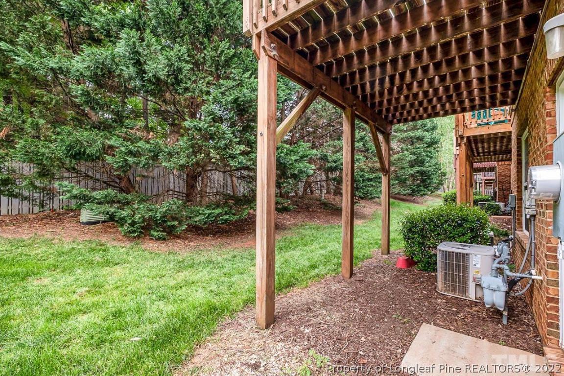 5441 Golden Arrow Lane Raleigh, NC 27613 - Photo 5 of 26 a view of a backyard with plants and outdoor seating