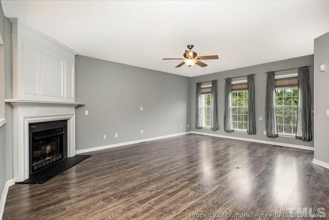 5441 Golden Arrow Lane Raleigh, NC 27613 - Photo 7 of 26 a view of an empty room with wooden floor and a window
