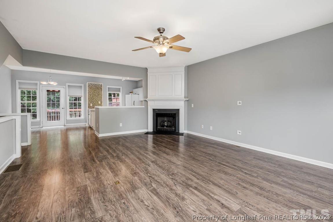 5441 Golden Arrow Lane Raleigh, NC 27613 - Photo 8 of 26 a view of a livingroom with wooden floor and a ceiling fan