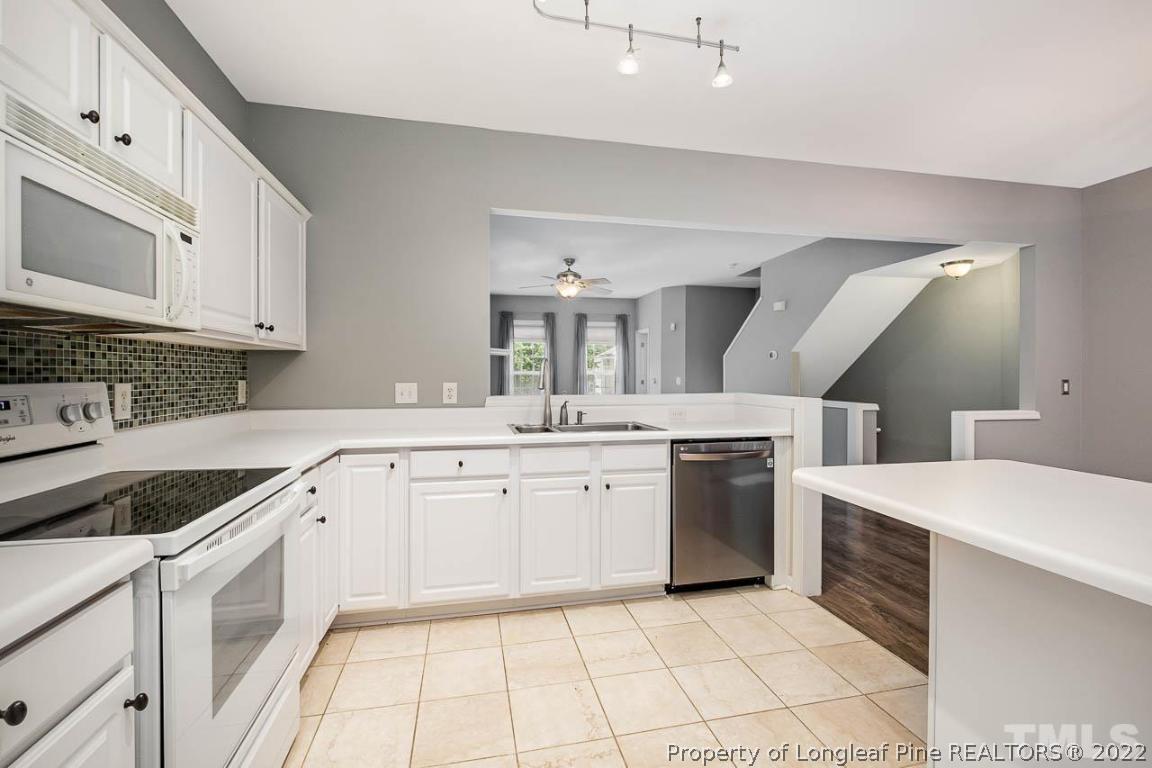 5441 Golden Arrow Lane Raleigh, NC 27613 - Photo 10 of 26 a kitchen with a sink stove and cabinets