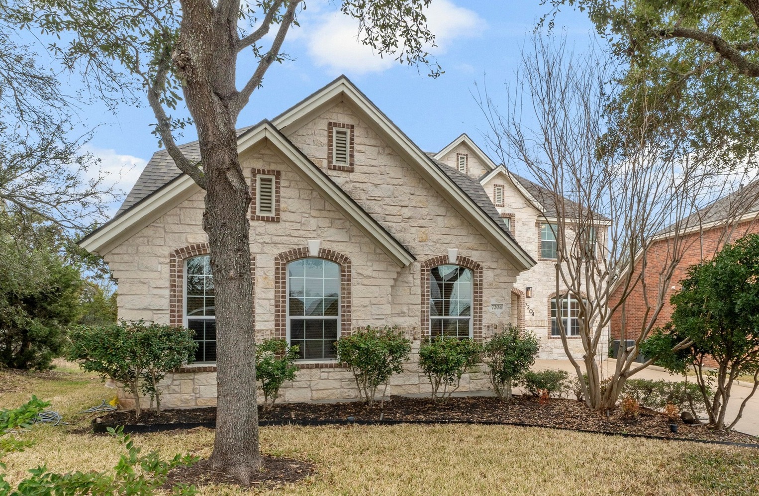 7204 Covered Bridge Drive Austin, TX 78736 - Photo 1 of 40 Welcome home. Side entry garage gives the front view of this home great curb appeal.
