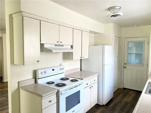 a kitchen with a stove and a refrigerator