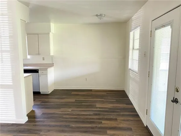 a view of a room with wooden floor and staircase