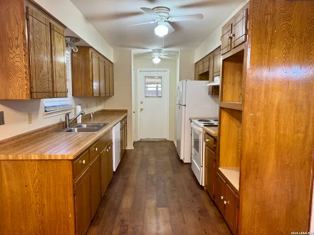 a kitchen with a sink stove and refrigerator