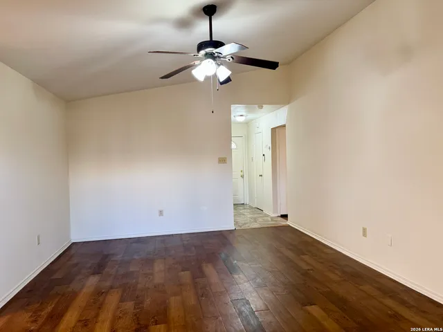 a view of a room with wooden floor