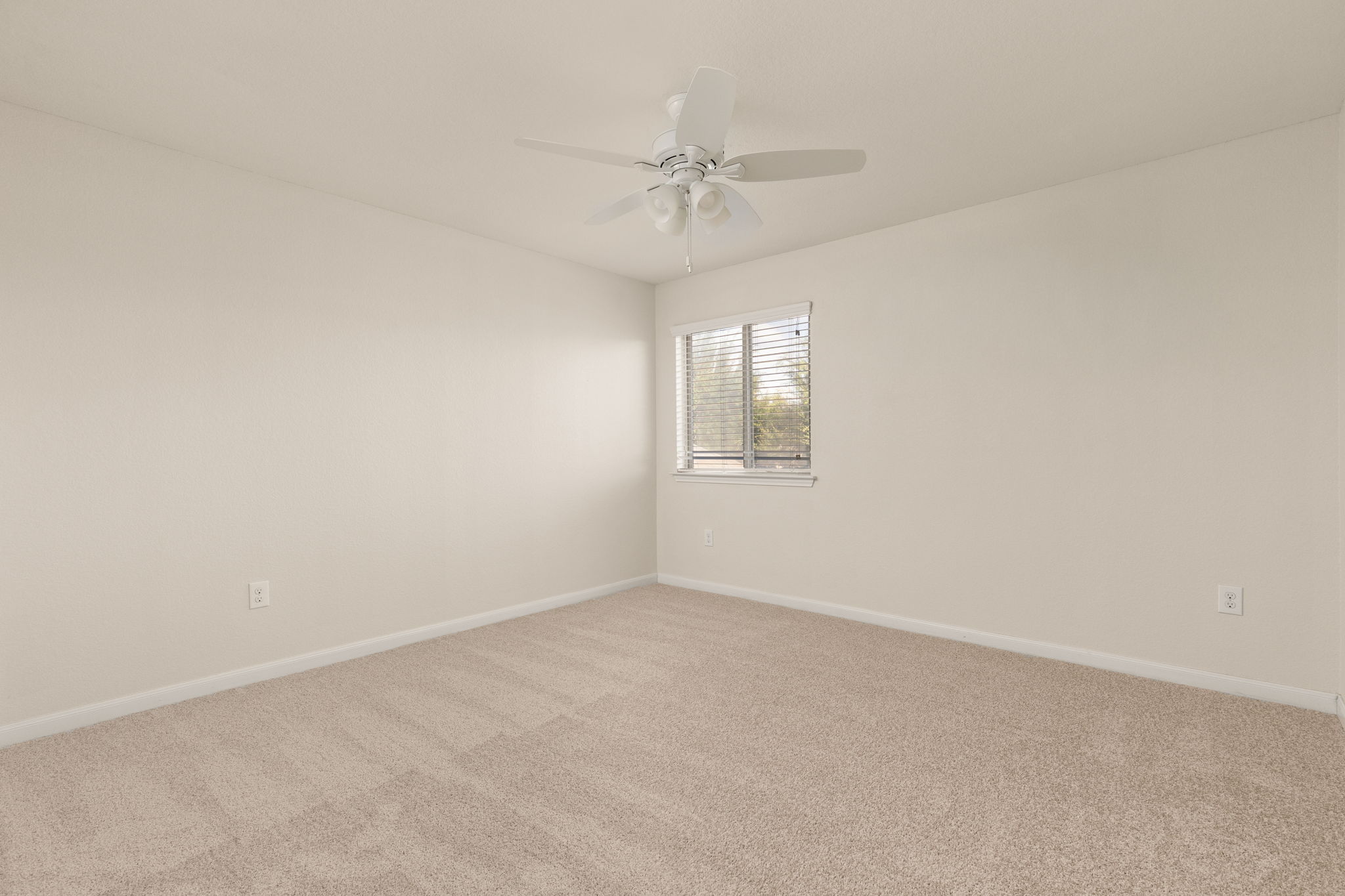 2400 Leonards Pass Leander, TX 78641 - Photo 34 of 40 A well-lit bedroom with carpeted floors and a cooling ceiling fan awaits your personal touch.
