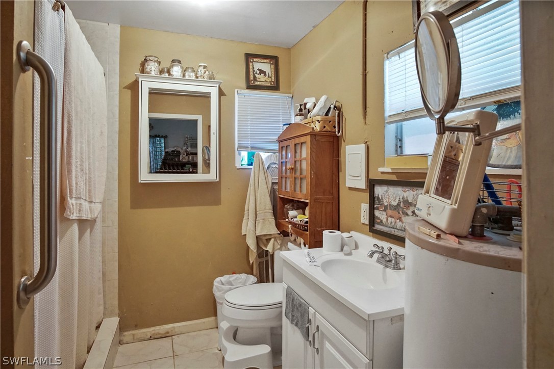 2631 Zeligro Road Alva, FL 33920 - Photo 8 of 35 a bathroom with a toilet sink and mirror