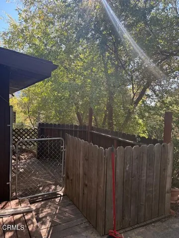 a wooden fence with trees in the background