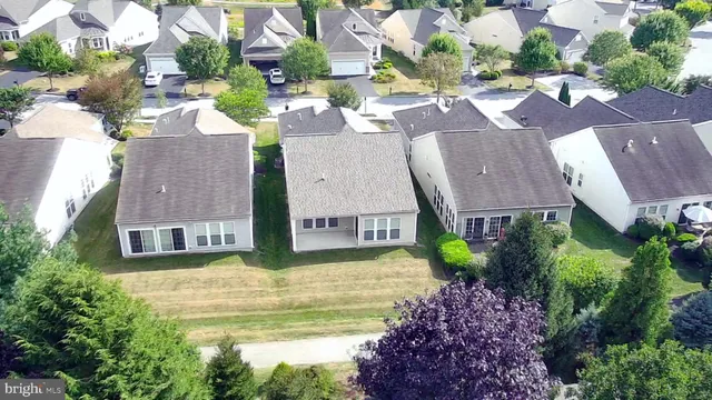 an aerial view of residential houses with yard