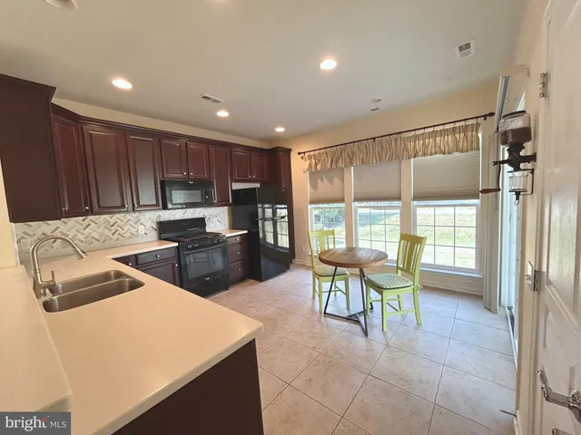 a kitchen with a table and chairs