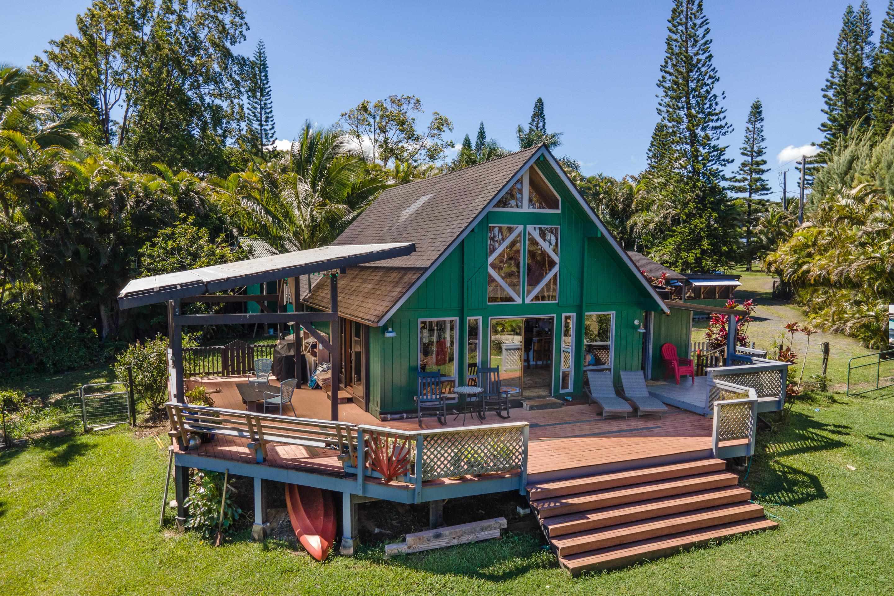 a front view of small house with yard and green space