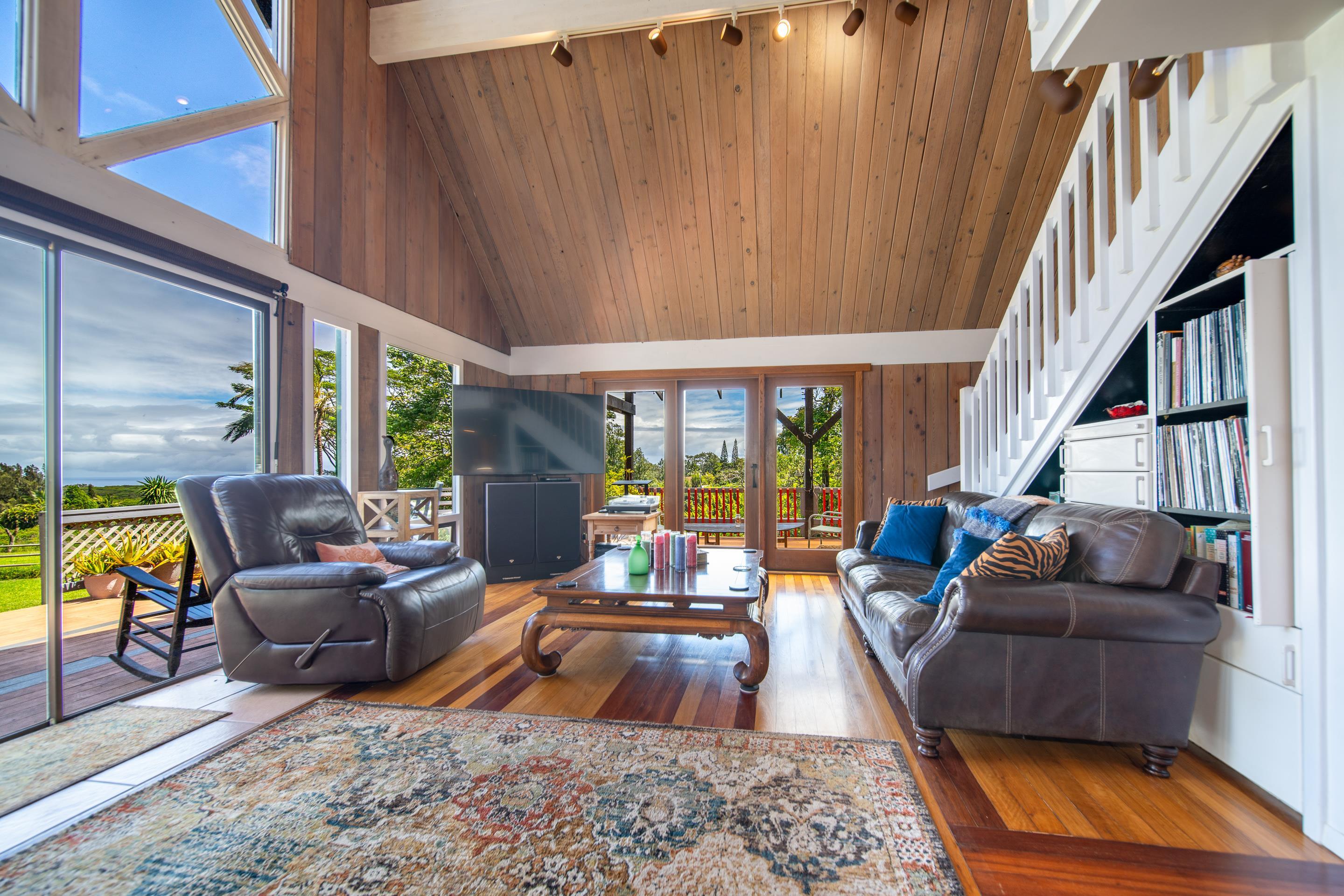 55 Oluolumau Place Haiku, HI 96708 - Photo 13 of 30 a living room with furniture fireplace and a large window