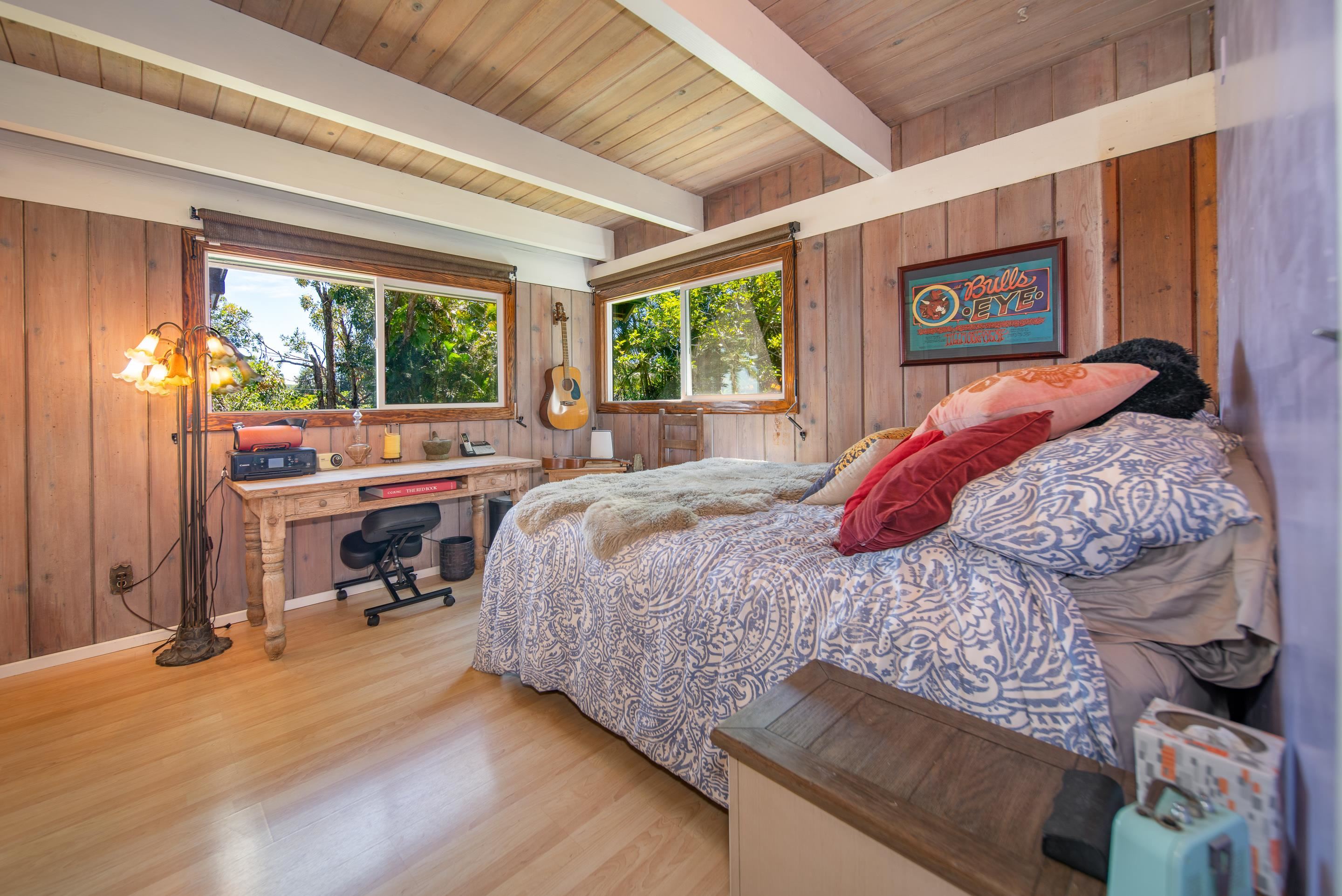 55 Oluolumau Place Haiku, HI 96708 - Photo 22 of 30 a bedroom with a bed and large windows