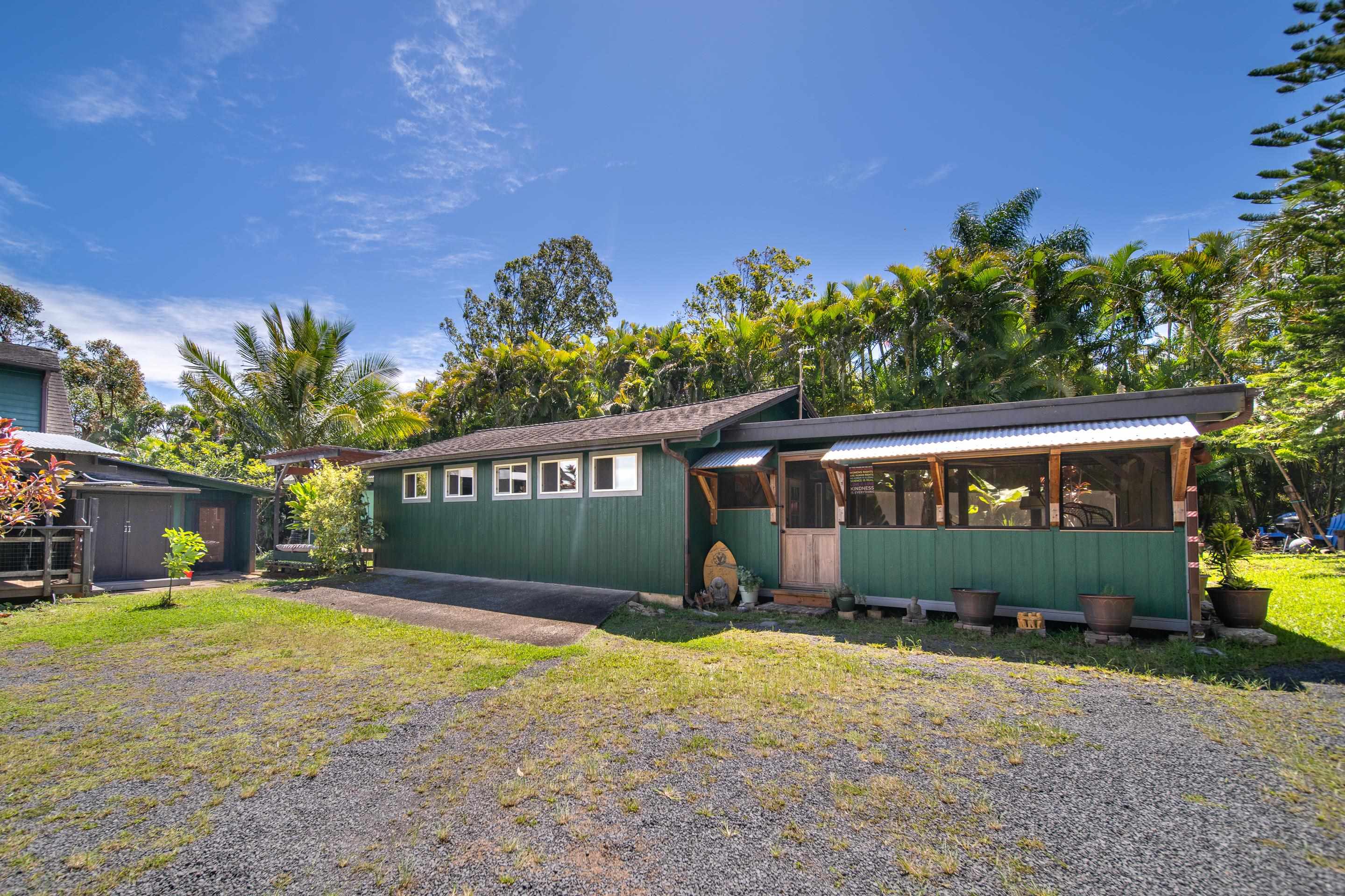 55 Oluolumau Place Haiku, HI 96708 - Photo 25 of 30 a front view of a house with a yard and garage